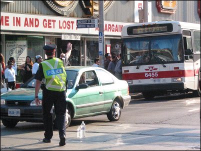 Traffic cop directs the chaos at Bloor and Bathurst.  In some intersections, ordinary people had jumped in to start directing traffic.